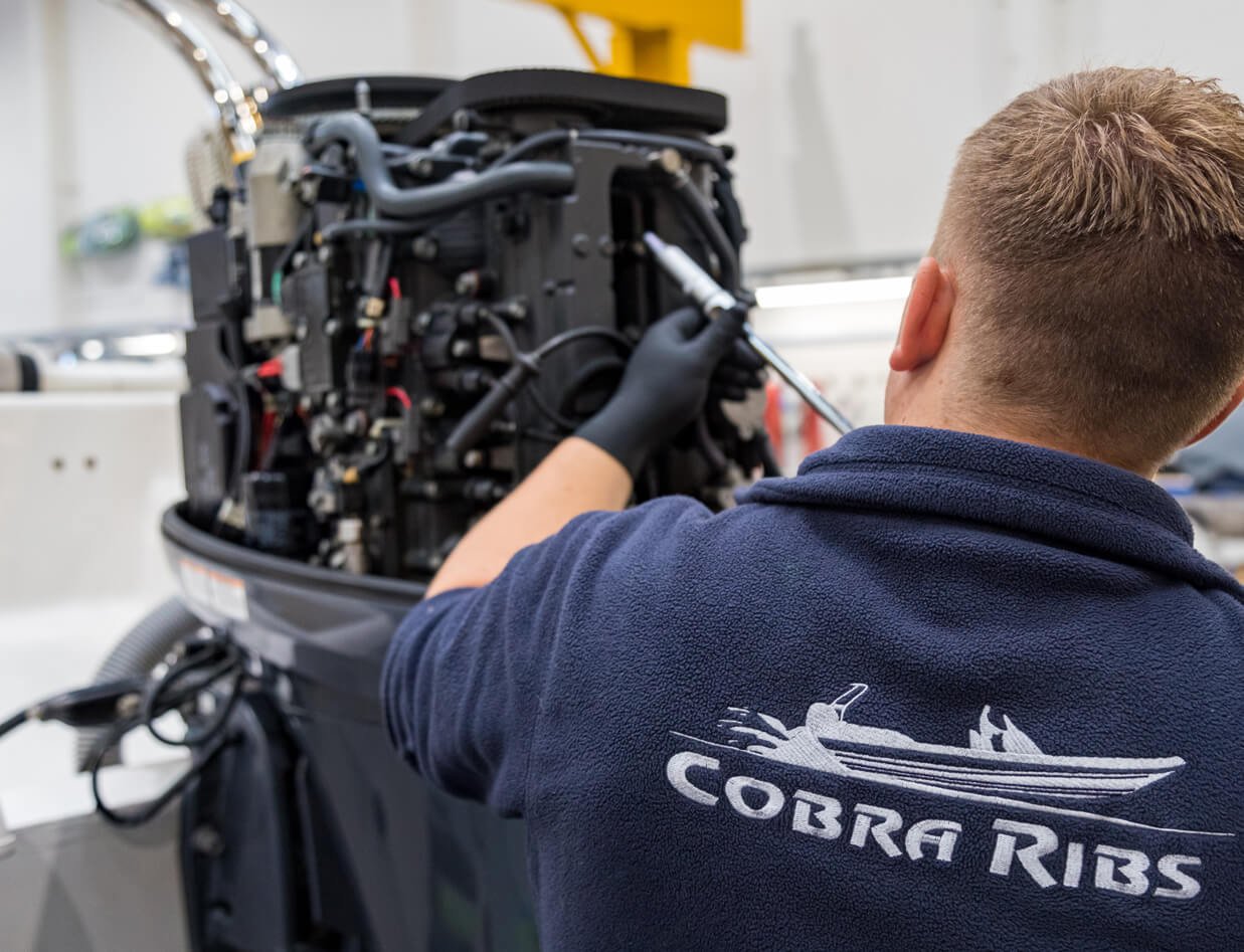 Cobra RIB craftsman working on RIB engine